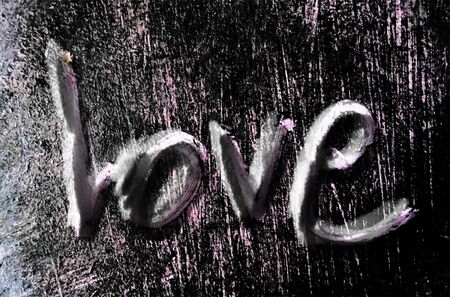 love painted, the word love hand-painted, artistic word love, rough shadowed hand-drawn lettering on dark grunge texture.の写真素材