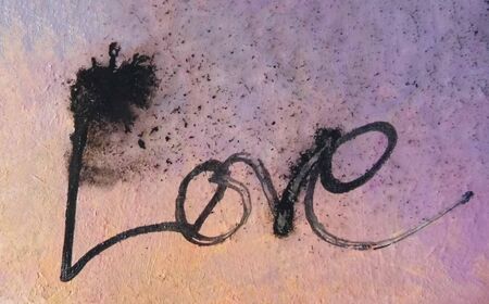 love painted, the word love hand-painted, artistic word love, partially washed-out Indian-ink brush lettering running on wet painted background.の写真素材