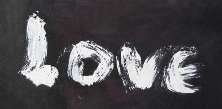 love painted, the word love hand-painted, artistic word love, pale rough painted brush lettering on rough gray painted texture.の写真素材