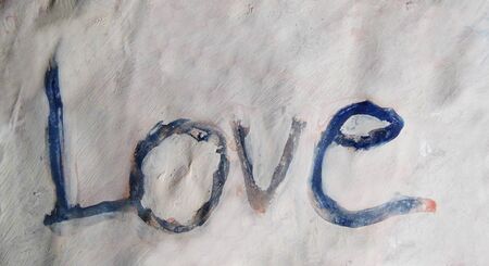 love hand-written, the word love written by hand, artistic word love, colored rough painted lettering on paint texture.の写真素材