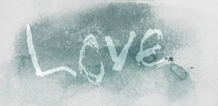 love hand-written, the word love written by hand, artistic word love, pale rough hand-made lettering on blue tinted watercolor texture.の写真素材
