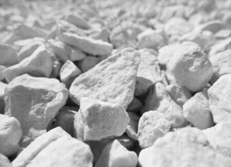 Rough white stones used as garden decorative surface, with shallow depth-of-field, focus on middle distance.の写真素材