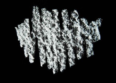 Chalk scribbled hashing in approximately oval shape on rough surface and black background.の写真素材