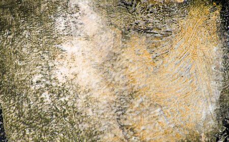Thick paint brush marks over-painted with warm yellow tints, organic painted texture background.