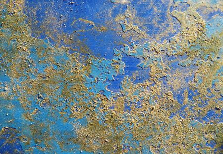 Distressed painted texture on a metal surface with scratches, rust and dirt, blue and yellow.の写真素材