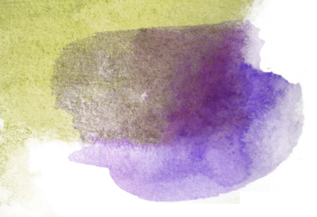 Layered watercolor brush strokes on partially wet watercolor paper, yellow and purple, on white background.の写真素材