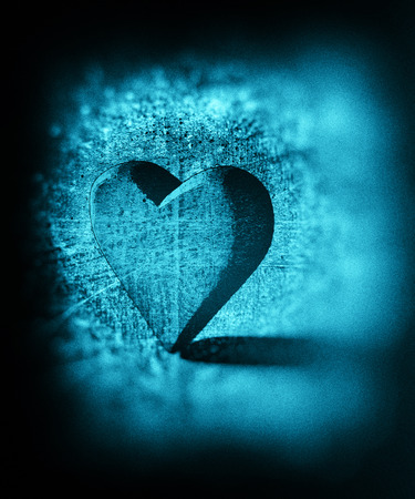 Grungy sketched 3D heart shape lit by single with diffuse shadow, colored pencil sketch style with dark blur vignette and scratches, artistic heart shape standing on end, blue tinted.の写真素材
