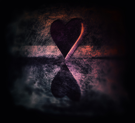 Sketched 3D heart shape lit by multiple colored lights, semi-gloss material, standing on end, on a smooth surface, on a textured area, orange, magenta and blue tints, with dark blur vignette.の写真素材
