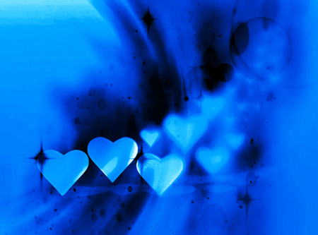 Many 3D hearts, a group of different sized blue heart shapes, with blur vignette, curved light and dark streaks, and blue tints.の写真素材