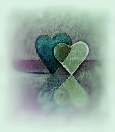 Sketched 3D heart shapes, watercolor style image of two glass hearts close together, one transparent, standing up, blue, green and purple tints, diffuse edges and blur vignette.の写真素材
