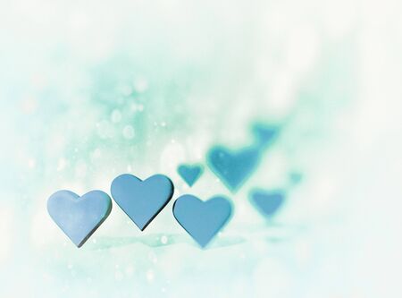 Many 3D hearts, a group of different sized heart shapes with shadows, with pale blur vignette and...