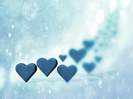 Many 3D hearts, a group of different sized blue heart shapes with shadows, with blur vignette and bokeh texture, blue tints.の写真素材