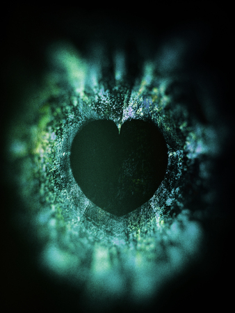 heart art, rough textured mixed-media fractal with heart shaped negative space, green tints and vignette blur.の写真素材