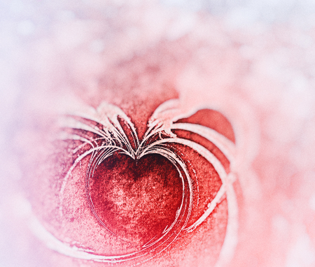 Painted fractal heart, rough painted flame fractal with heart shaped negative space, on rough painted texture, red tints and blur vignette.の写真素材