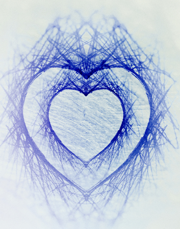 Double heart, a symmetrical heart-shaped negative space left by pencil scribbling, duplicated larger, on artistic texture, with vignette blur and blue tints.の写真素材