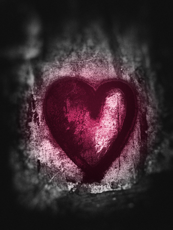 Grunge heart, rough painted heart shape on rough painted concrete texture, grays with magenta tints, blur vignette.の写真素材