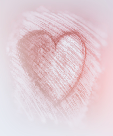 Sketched heart, a heart shape drawn roughly with chalk and charcoal, blur vignette, with red tints.の写真素材