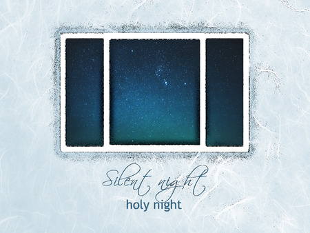 Christmas card with the words Silent Night, Holy Night, in contemporary fonts, with night sky seen through window, blue and green tints and long-fiber Japanese paper texture.の写真素材
