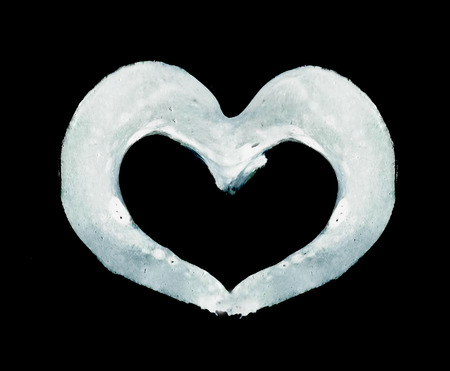 Rough painted heart-shape outline on rough surface. Black background.の写真素材