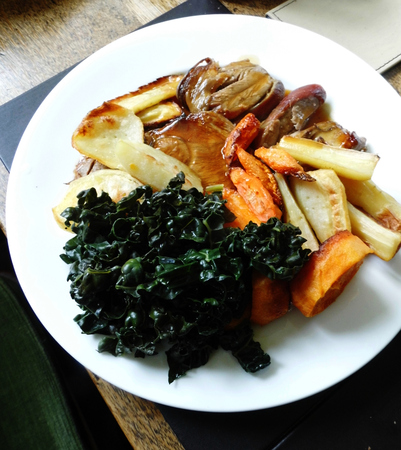 Roast lamb with vegetables on a plate on a table.の写真素材