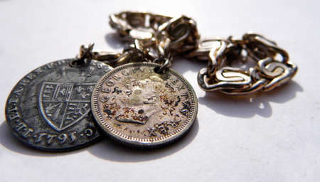 A silver bracelet with old coins, closeup,の写真素材