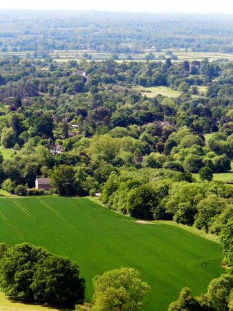 British summer landscape, from a hill, with fields, farms and forests, Surrey, UK.の写真素材