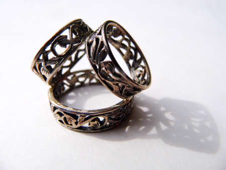 Silver scarf ring on a flat surface with shadow.の写真素材