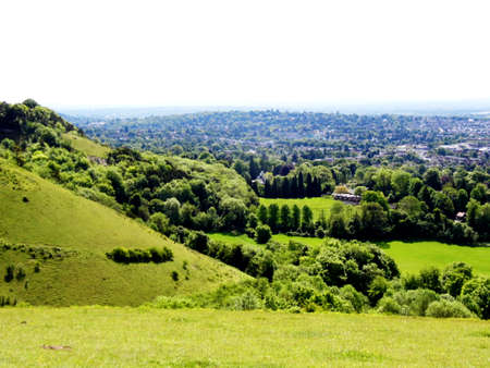 British summer landscape, from a hill, with fields, farms and forests, Surrey, UK.の写真素材