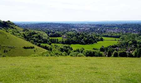 British summer landscape, from a hill, with fields, farms and forests, Surrey, UK.の写真素材