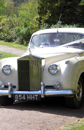 An old white Rolls Royce motorcar in use for a wedding.のeditorial素材
