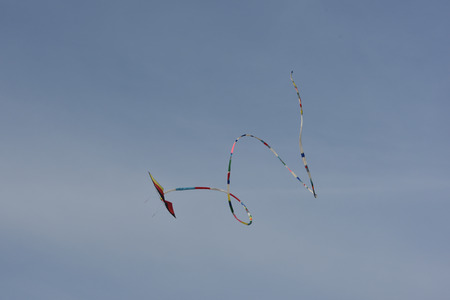 kite flying hight in the sky with acrobatic movementsの写真素材