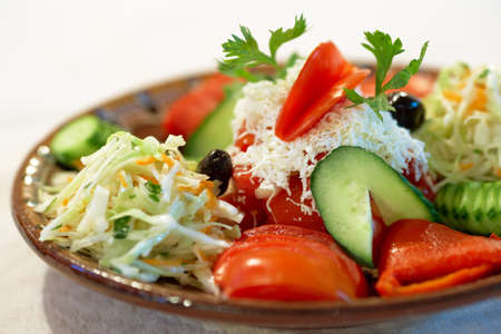 Vegetables salad with tomatoes, cabbage and white Bulgarian Feta cheeseの写真素材