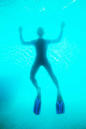 Scuba diver in deep blue waterの写真素材