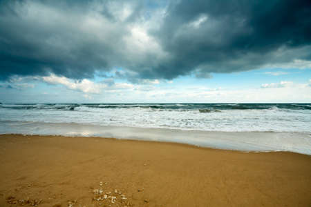 Winter sea with cloudy sky and wavesの写真素材