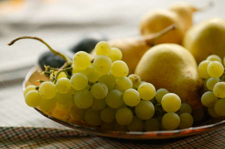 Ripe autumn fruits in a dish close-upの写真素材