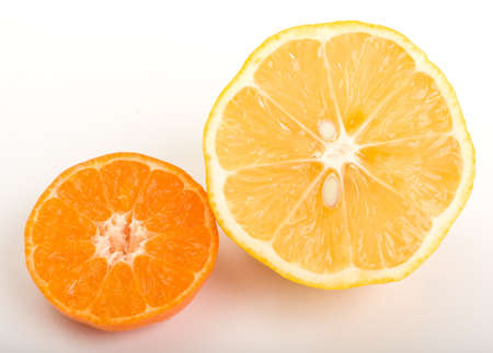 Sliced mandarin and lemon on whiteの写真素材
