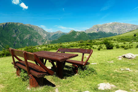 Table and seats at the trail to Botev peak, the high mountains of the Bulgarian Balkansの写真素材