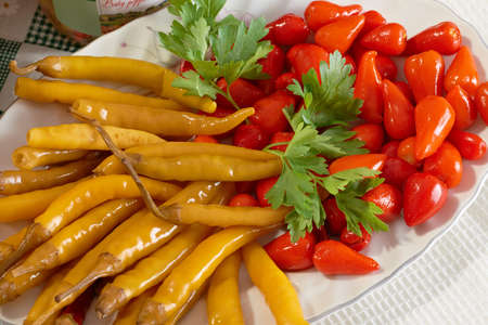 Hot pickled red and green pepperoniの写真素材