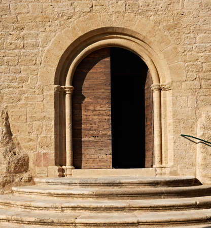 The gate of the ancient cathedral in the village Ansouis, Franceの写真素材