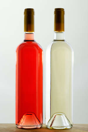 Two bottles of red and white wine, sealed, without labelsの写真素材