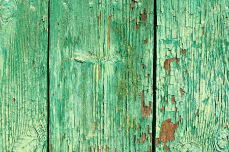 Old cracked green paint on wooden surface textured backgroundの写真素材