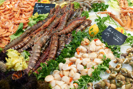 Freash and baked shrimps and clams on fish market stall for sale in Provence, Franceの写真素材