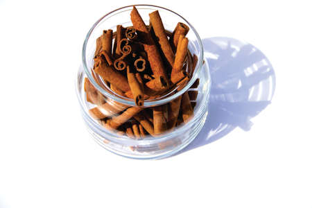 Cinnamon bark in container on white background