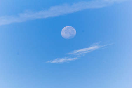 blue sky with white cloud and moonの写真素材