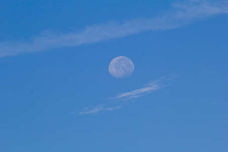 blue sky with white cloud and moonの写真素材