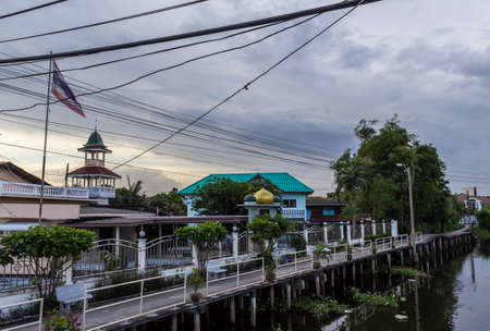 Urban ghetto house village canal side in Bangkok Thailand.の写真素材