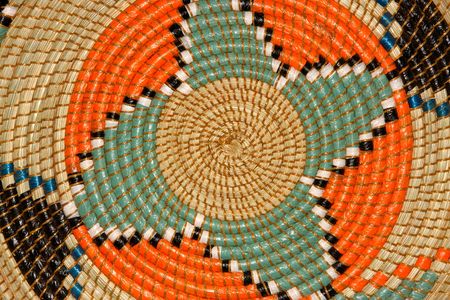 Colorful pattern on a hand woven African basket	の写真素材