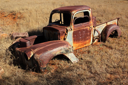Wreck of a rusty old pickup truck out in the field の写真素材