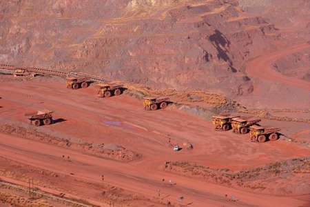 Large, open-pit iron ore mine with trucks