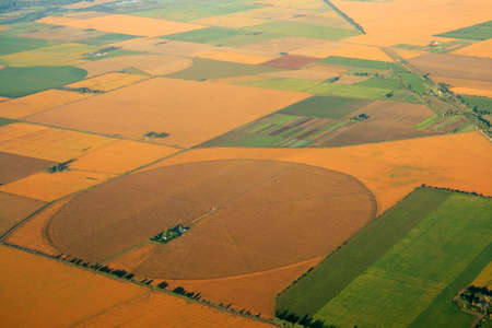 Aerial view of farmland with a mosaic of cultivated land and planted crops 